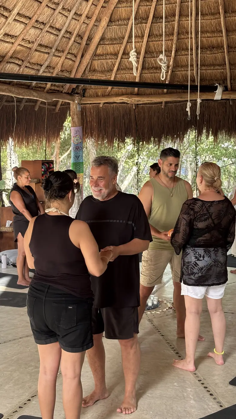 Embrace between participants during a spiritual retreat in Tulum